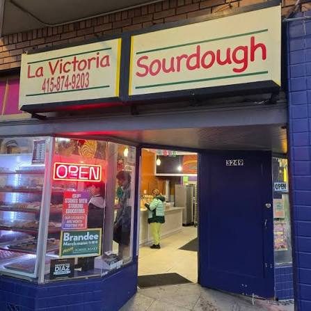 Current La Victoria storefront with La Victoria and Sourdough signs and the entrance open.
